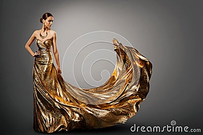 Woman Gold Dress, Fashion Model in Long Waving Gown, Young Girl Beauty Stock Photo