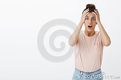 Woman got robbed being freak out and panicking realising she lost everything holding hands on head in shocked pose Stock Photo