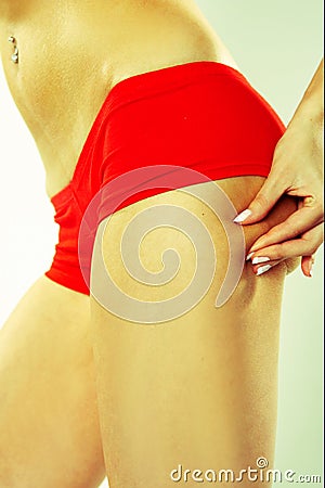 Woman Grabbing at Her Buttocks Stock Photo