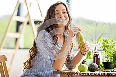 Woman with green healthy food and drinks at home Stock Photo