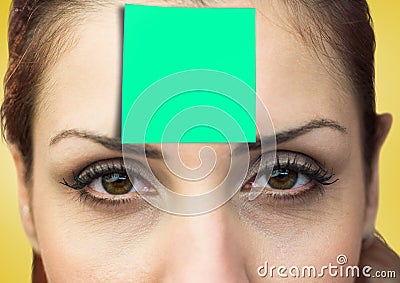 Woman with green sticky note on her forehead Stock Photo
