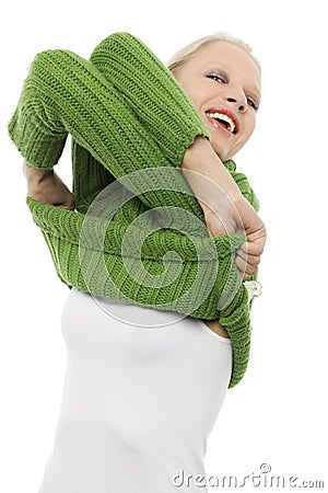 Woman with green turtleneck undressing Stock Photo