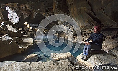 Woman in GrjÃ³tagjÃ¡ cave, Iceland Stock Photo