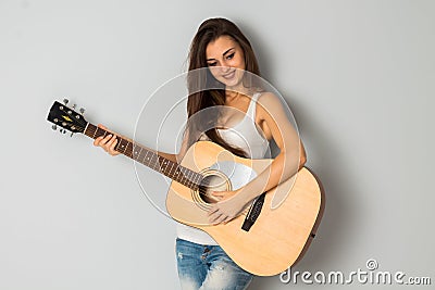 Woman with guitar looking away and smiling Stock Photo