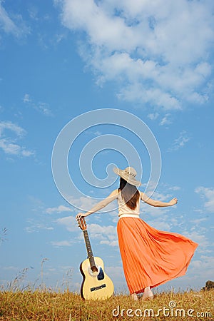 Woman and guitar standing and Cloud sky Stock Photo