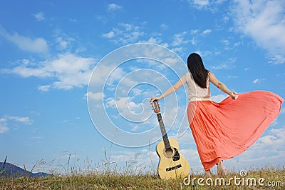 Woman and guitar standing and Cloud sky Stock Photo