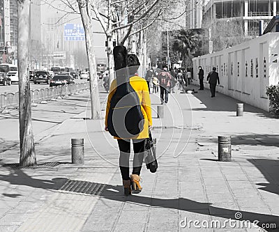 guitar girl walking on road Editorial Stock Photo