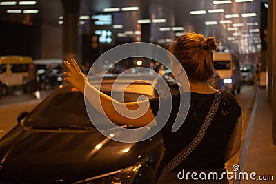 Woman hailing for cab. Stock Photo