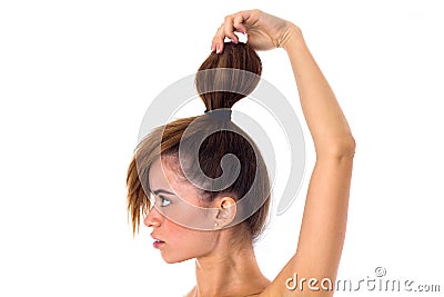 Woman with hair in a bun standinf sidewise Stock Photo