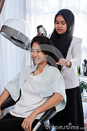 Woman hair dryer at salon Stock Photo