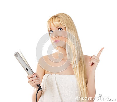 Woman with hair straighteners Stock Photo