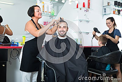 Woman hairdresser and man client Stock Photo