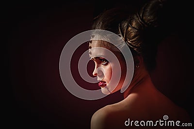 Woman in Halloween makeup with hairstyle in form of horns, Devil Queen Stock Photo