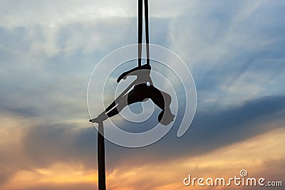 Woman in a hammock doing stunts. Stock Photo