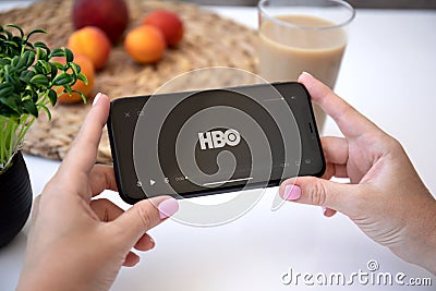 Woman hand Apple iPhone with HBO video on the screen Editorial Stock Photo