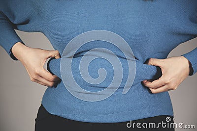 Woman hand belly fats Stock Photo