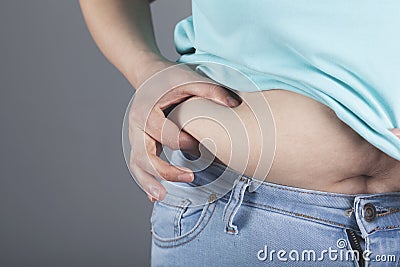 Woman hand belly fats Stock Photo