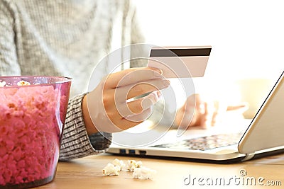 Woman hand buying movies on line in a laptop Stock Photo