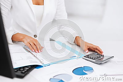 Woman hand with calculator and papers Stock Photo