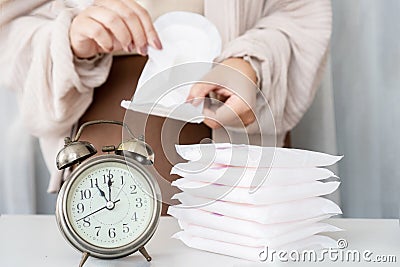 woman hand changing sanitary pads often during period Stock Photo