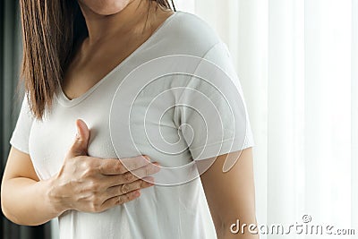 Woman hand checking lumps on her breast for signs of breast cancer. Women healthcare concept Stock Photo
