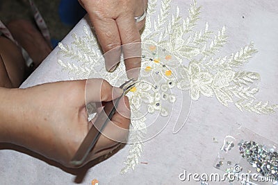 Woman Hand with Corporate Tools Materials gold shining beads for this a Big Long Gown in Ellanie's Shop Surigao City Stock Photo