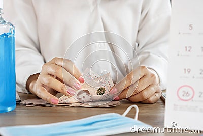 Woman hand counting Thai baht banknotes with calendar and due date ,deadline for debt payment during covid-19 crisis Stock Photo