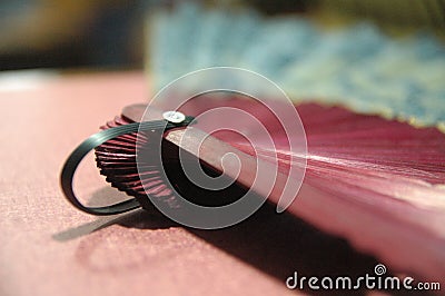 Woman hand fan wooden red color close up Stock Photo