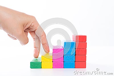 Woman hand finger walk on stacked wooden block like stairs. Business development and growth concept Stock Photo