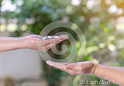 Woman hand give money coin to hand Stock Photo