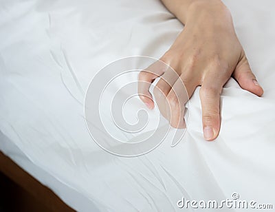 Woman hand grasp bed sheet Stock Photo