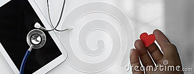 Woman hand with heart computer tablet with stethoscope for doctor health diagnosis tele medicine business on white background Stock Photo