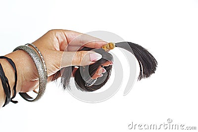 Woman hand holding blach human hair tail on isolated white background. Studio photo with studio lighting easy to use for every con Stock Photo