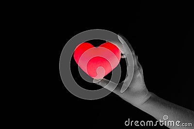 Woman hand holding blank red heart on dark background Stock Photo