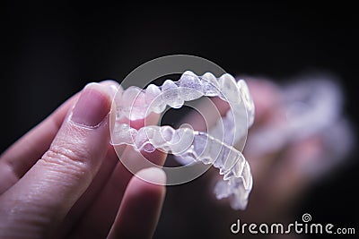 Woman hand holding invisible orthodontics Stock Photo