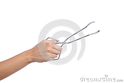 Woman hand holding an opened kitchen tongs Stock Photo
