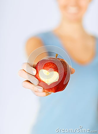 Woman hand holding red apple with heart shape Stock Photo