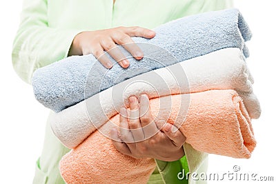 Woman hand holding spa towels stack white isolated Stock Photo