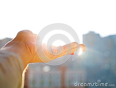 Woman hand holding the sun Stock Photo