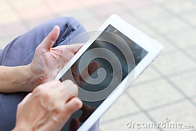 Woman hand on iPad Stock Photo