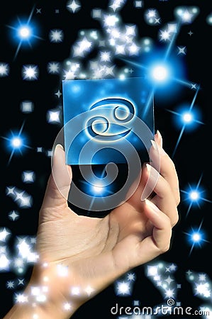 Woman hand keeping a blue card with zodiac symbol of Cancer like astrology concept Stock Photo