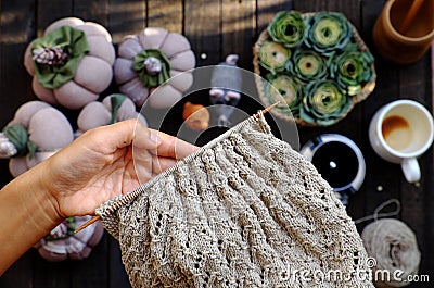 Woman hand knit handmade product with pumpkin background at morning coffee time Stock Photo