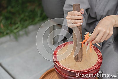 Woman hand making thai food call papaya salad or Som Tam, mixing and pounding in a mortar Stock Photo