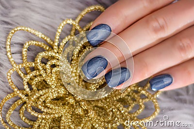 Navy Blue Manicure with Golden Flower: Elegant Nail Art Concept Stock Photo