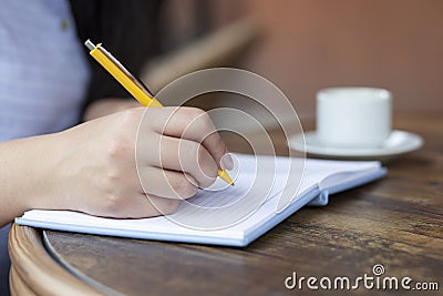 Woman hand notepad and coffee Stock Photo