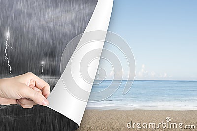 Woman hand open calm beach page replace stormy ocean Stock Photo