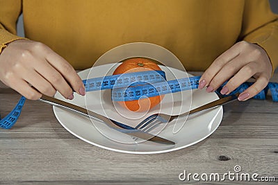 Woman hand orange on plate Stock Photo