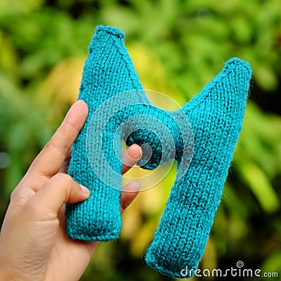 Woman hand pick knitted alphabet Stock Photo
