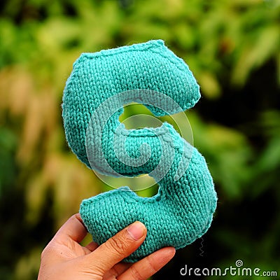 Woman hand pick knitted alphabet Stock Photo