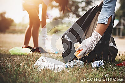 woman hand picking up garbage plastic for cleaning Stock Photo